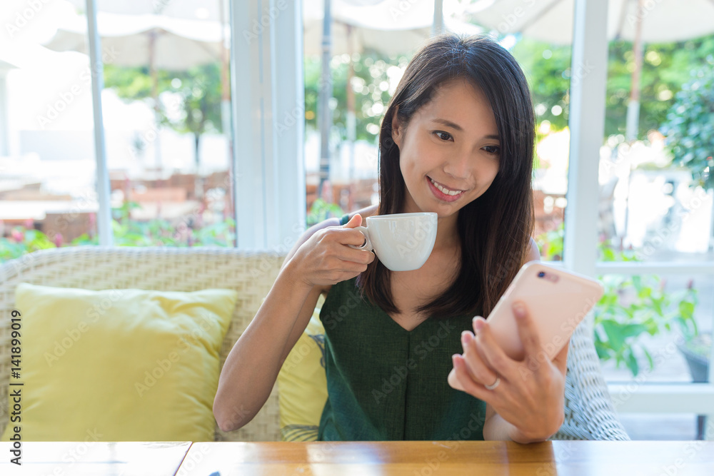 Woman using mobile phone in coffee shop Woman using mobile phone in coffee shop
