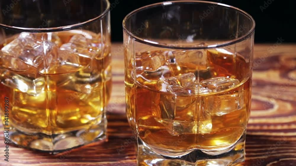 glasses of malt whiskey on a black table. video slider glasses of malt whiskey on a black table. video slider