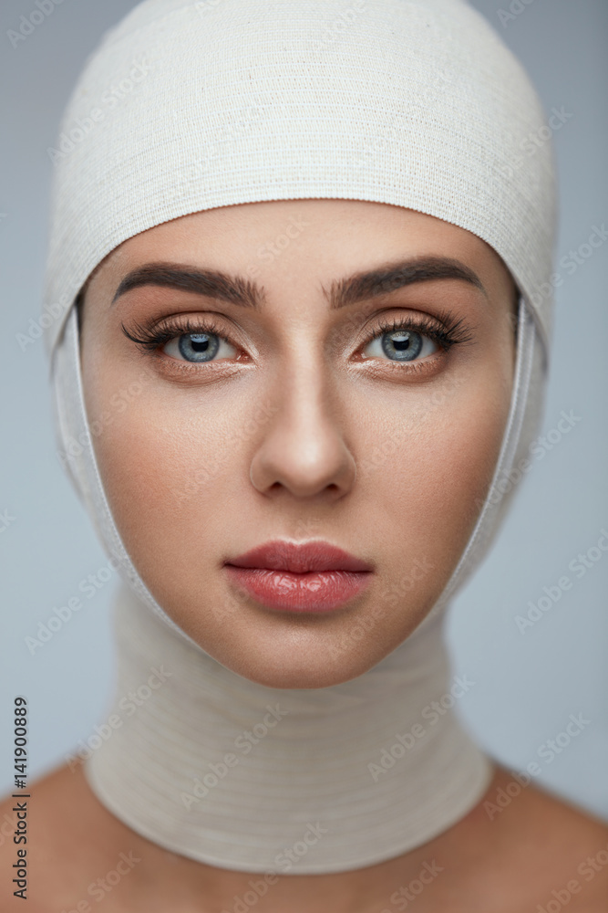 Woman Face With Smooth Soft Skin And Perfect Makeup In Bandages