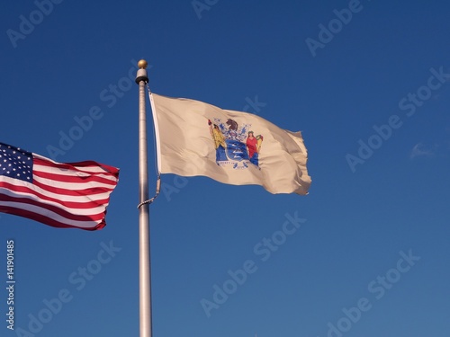 New Jersey state flag waving with American Flag waving along side with it. photo