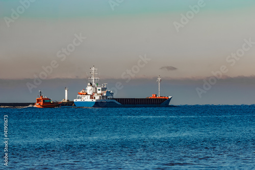 Blue cargo ship leaving Riga and entering Baltic sea