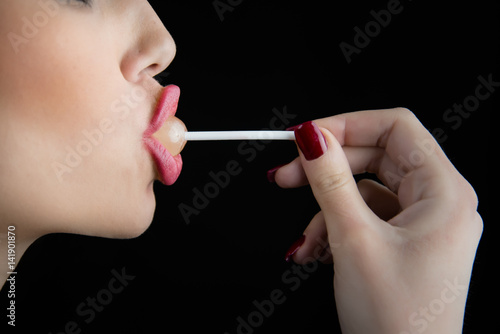 Photos Juicy big lips of a young woman in profile suck a lollipop, nice long thin finge