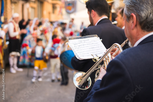 Trompetista tocando con su banda en un desfile fallero en Valencia. photo