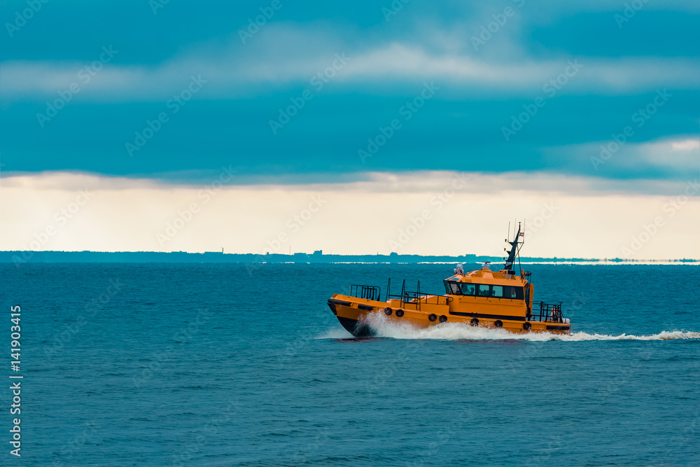 Orange pilot ship moving fast in Baltic sea. Europe Orange pilot ship moving fast in Baltic sea. Europe