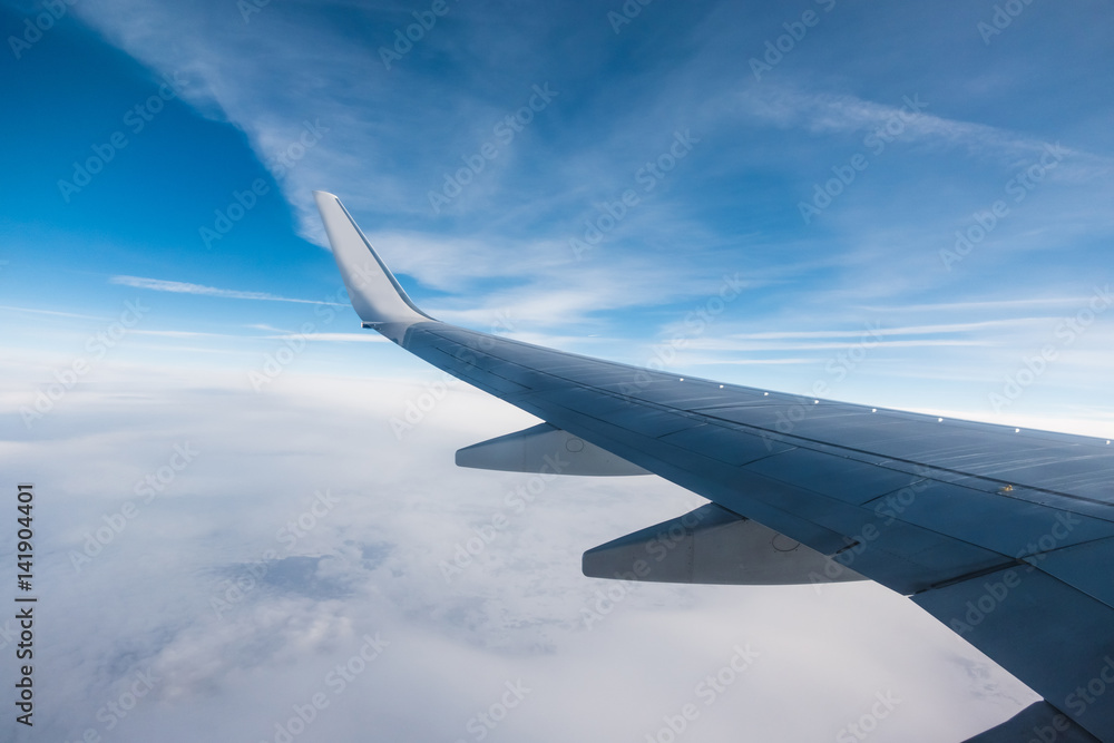 Wing of an aircraft and cloudy sky Wing of an aircraft and cloudy sky