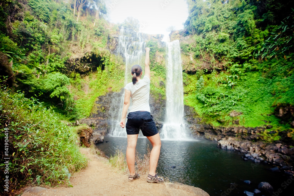 Winner near waterfall. Active life concept Winner near waterfall. Active life concept