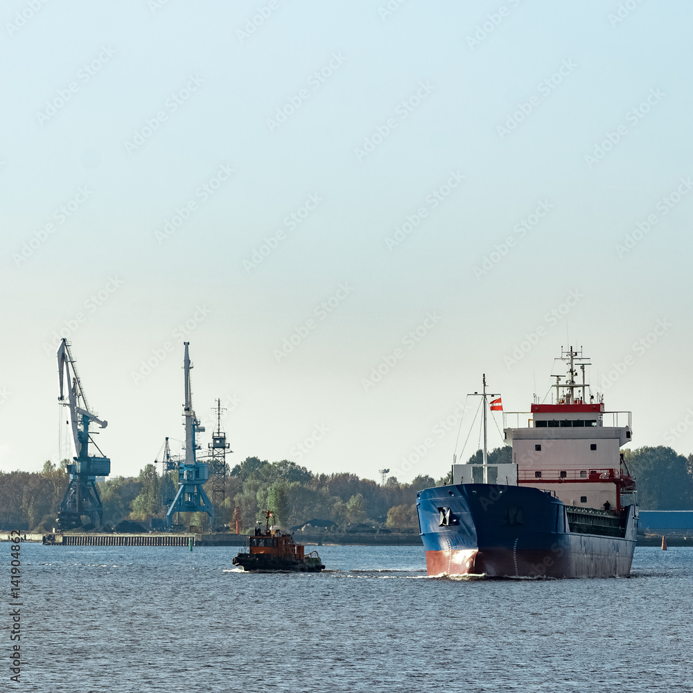 Blue cargo ship leaving the port of Riga