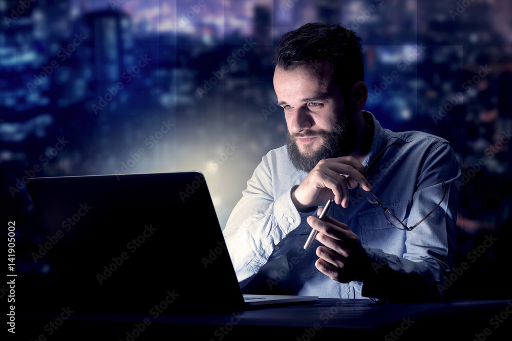 Businessman in the office at night Businessman in the office at night