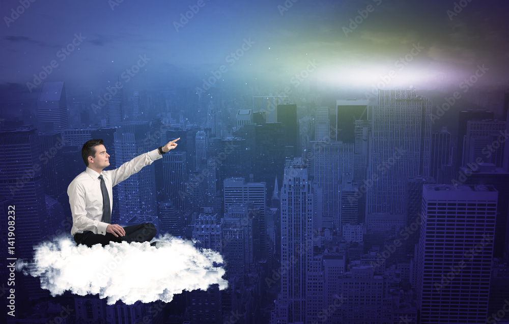 Man sitting on a cloud above the city Man sitting on a cloud above the city