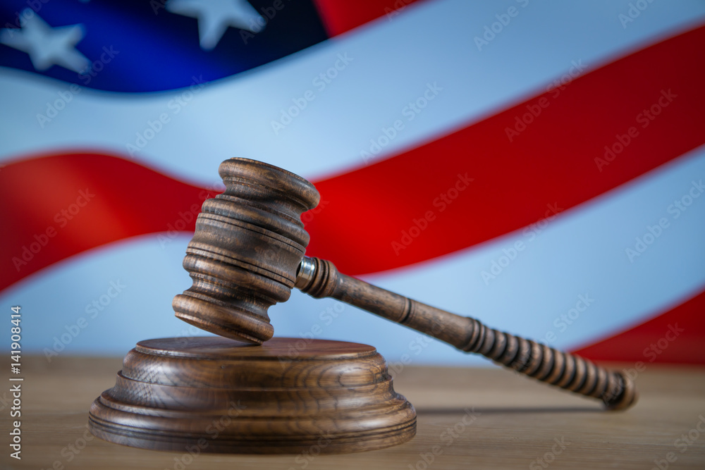 Law concept Gavel and Lady of Justice on wooden table, USA flag