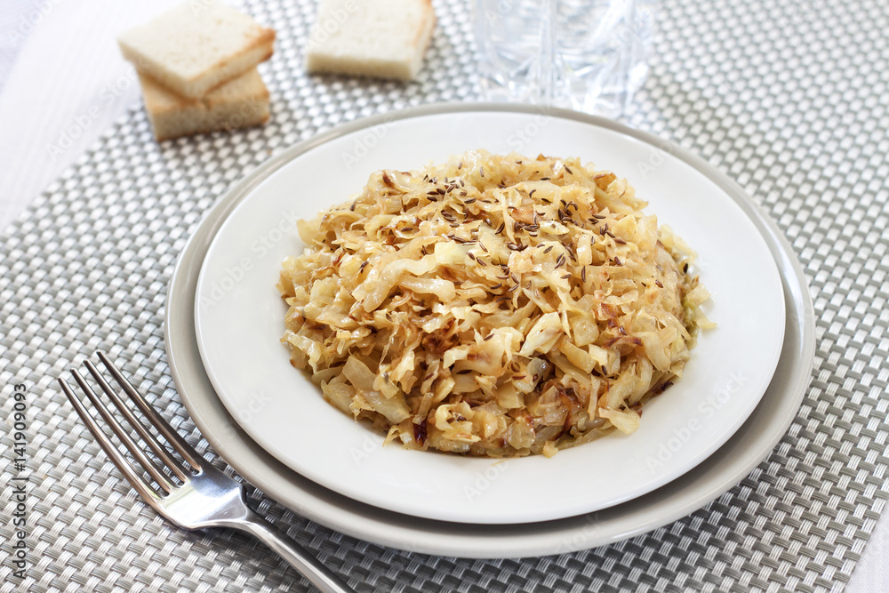 Fried cabbage with caraway and garlic on a plate Fried cabbage with caraway and garlic on a plate