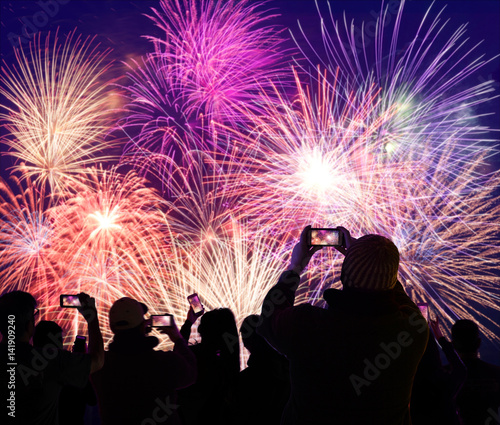 Crowd Watching and Recording Fireworks on Cellphones