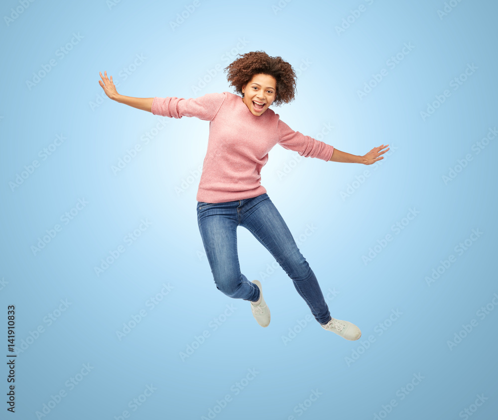 happy african american woman jumping over white Stock-Foto | Adobe Stock