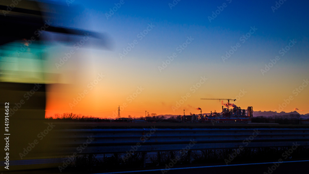 sun goes down behind an industry sun goes down behind an industry