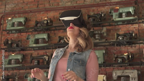 woman uses a virtual reality glasses in interior photo