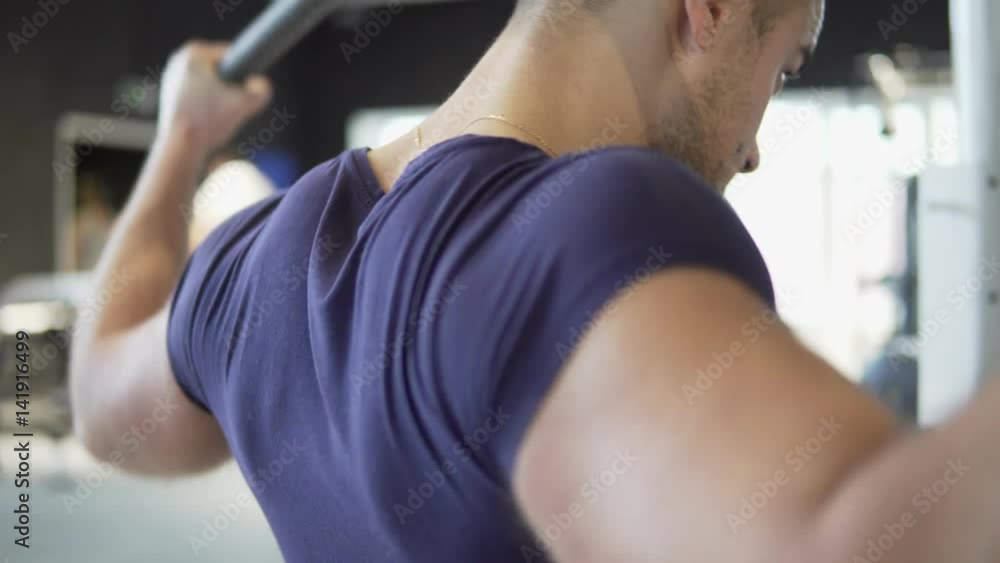 A young athletic man is training in the gym. 4K A young athletic man is training in the gym. 4K