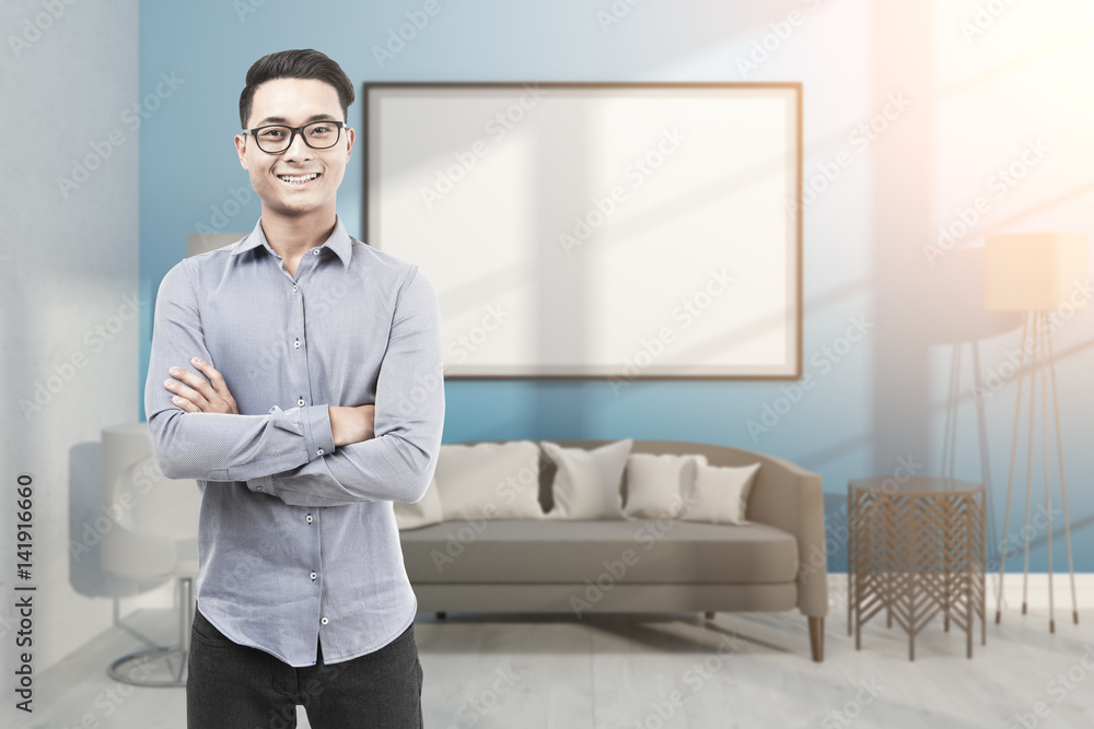 Fototapeta premium Asian man in glasses in blue room with whiteboard