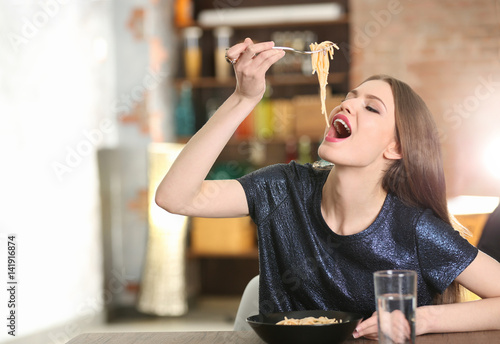 Beautiful woman eating past...