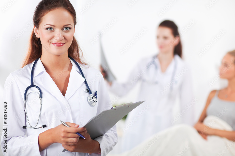 Woman doctor with folder standing at hospital Woman doctor with folder standing at hospital
