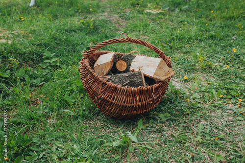Vintage basket with firewood outdoor in the countryside