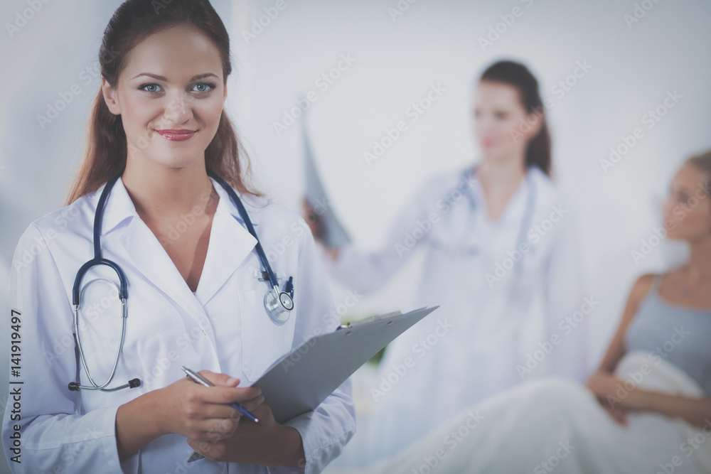 Woman doctor with folder standing at hospital Woman doctor with folder standing at hospital