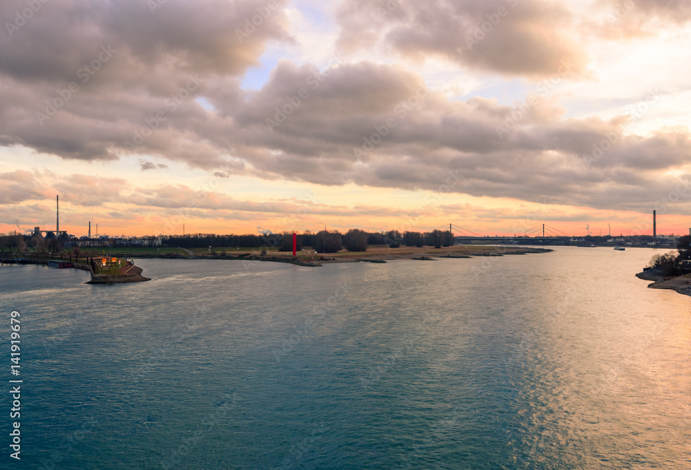 Sunset or sunrise over the rhine with ships and iconic landmarks