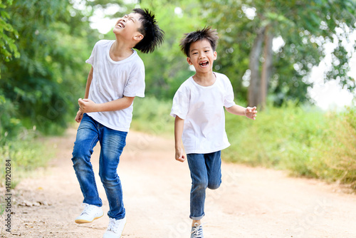 Two boy run in the park