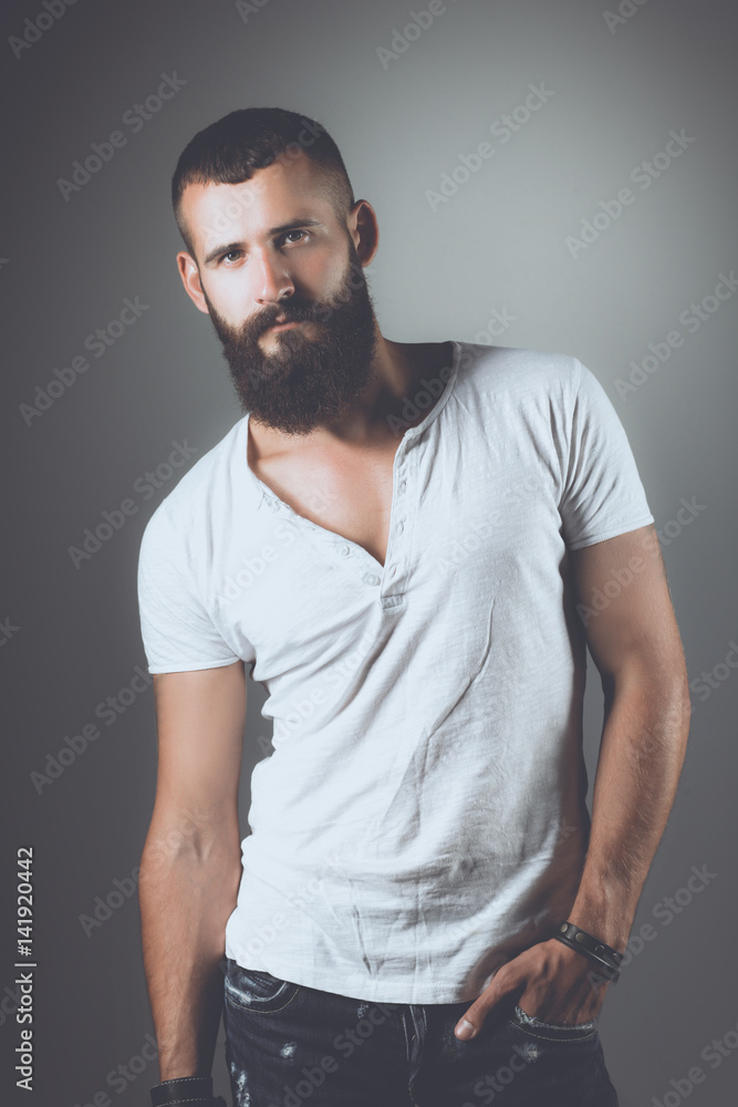 Portrait of handsome man standing, isolated on grey background Portrait of handsome man standing, isolated on grey background