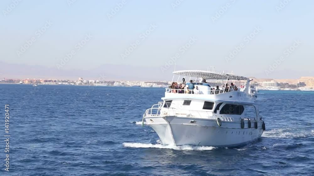 HURGHADA, EGYPT - FEBRUARY 13, 2016: Tour boat with tourists on the Red sea HURGHADA, EGYPT - FEBRUARY 13, 2016: Tour boat with tourists on the Red sea