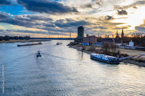 Sunset or sunrise over the rhine with ships and iconic landmarks