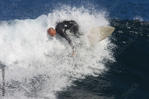 A surfer makes a turn in a breaking wave. © Rapt.Tv