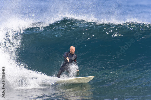 A surfer carves across a breaking wave. © Rapt.Tv