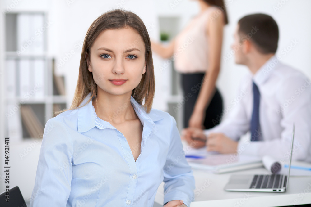 Portrait of a young business woman at meeting. Portrait of a young business woman at meeting.