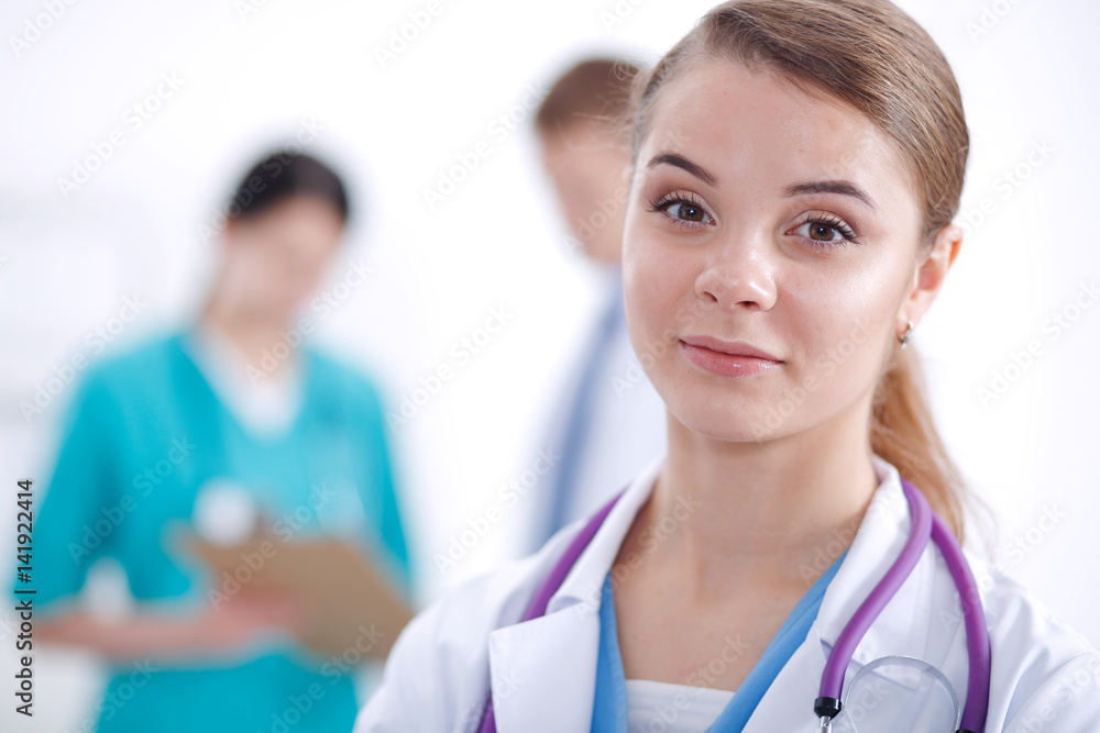 Woman doctor standing with folder at hospital Woman doctor standing with folder at hospital