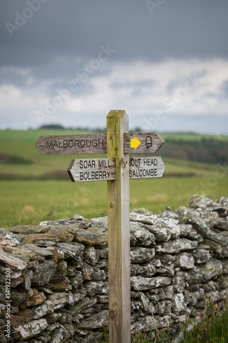 Wooden sign post for the South West Coast Path on the coast near Hope Cove, Bolberry and Cop Soar, Devon, England, UK