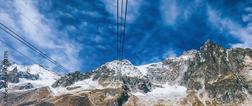 Snowy mountain and cloudy sky seen from cable car letterbox