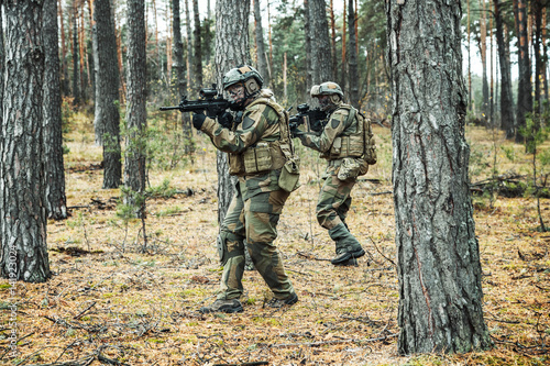 Pair of norwegian Rapid reaction special forces FSK soldiers in field uniforms in action in the forest © Getmilitaryphotos