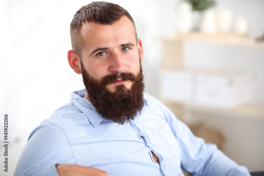 Young businessman sitting on chair in office Young businessman sitting on chair in office