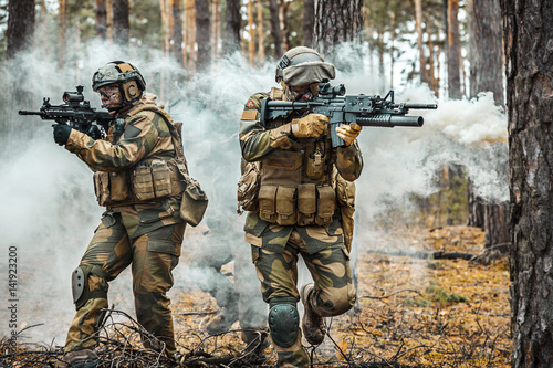 Norwegian Rapid reaction special forces male and female FSK soldiers in field uniforms in action in the forest fog