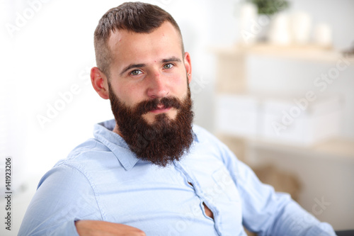 Young businessman sitting on chair in office