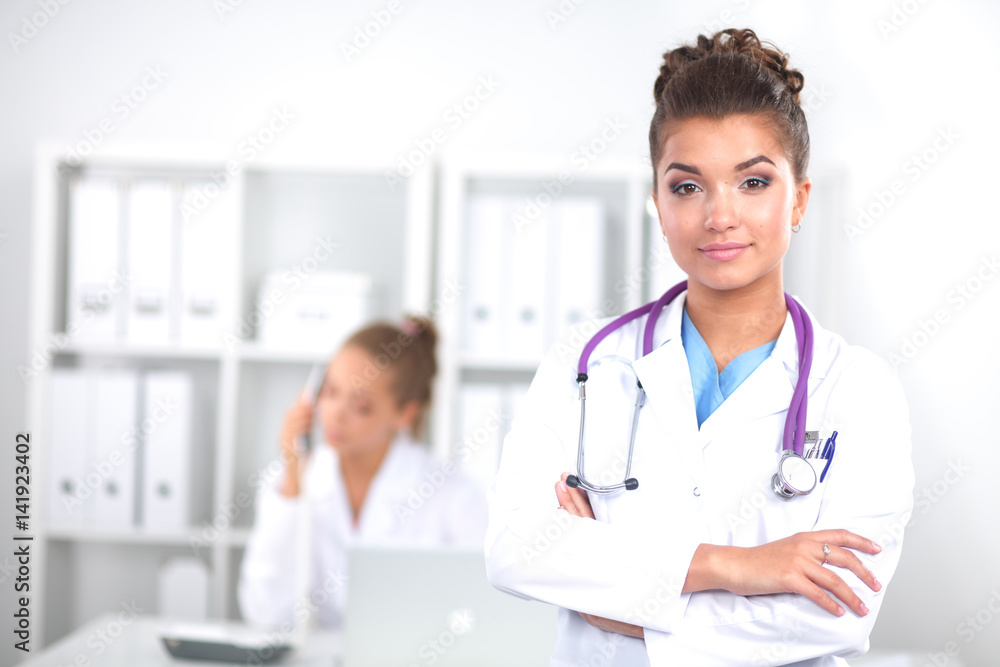 Woman doctor standing with folder at hospital Woman doctor standing with folder at hospital