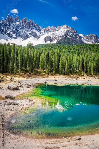 Sunny day in mountain Carezza lake in Dolomites, Italy, Europe