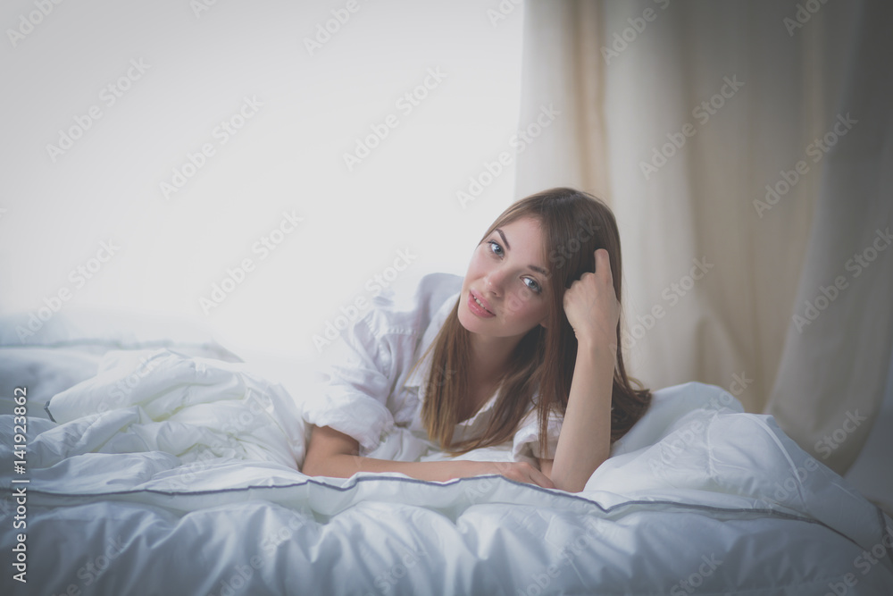 Portrait of beautiful woman on bed at bedroom Portrait of beautiful woman on bed at bedroom