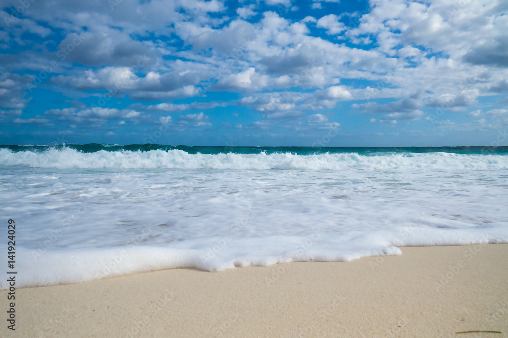 A nice tropical beach view of the ocean with clouds in the sky. New Providence, Nassau, Bahamas. A nice tropical beach view of the ocean with clouds in the sky. New Providence, Nassau, Bahamas.