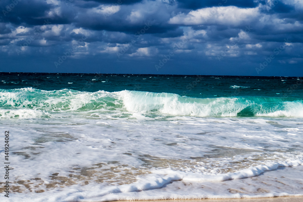 A nice tropical beach view of the ocean with clouds in the sky. New Providence, Nassau, Bahamas.