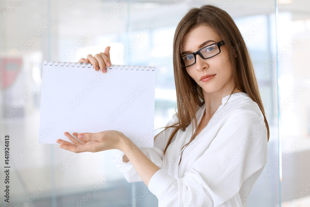 Business woman keeping copy space area while standing in the office Business woman keeping copy space area while standing in the office