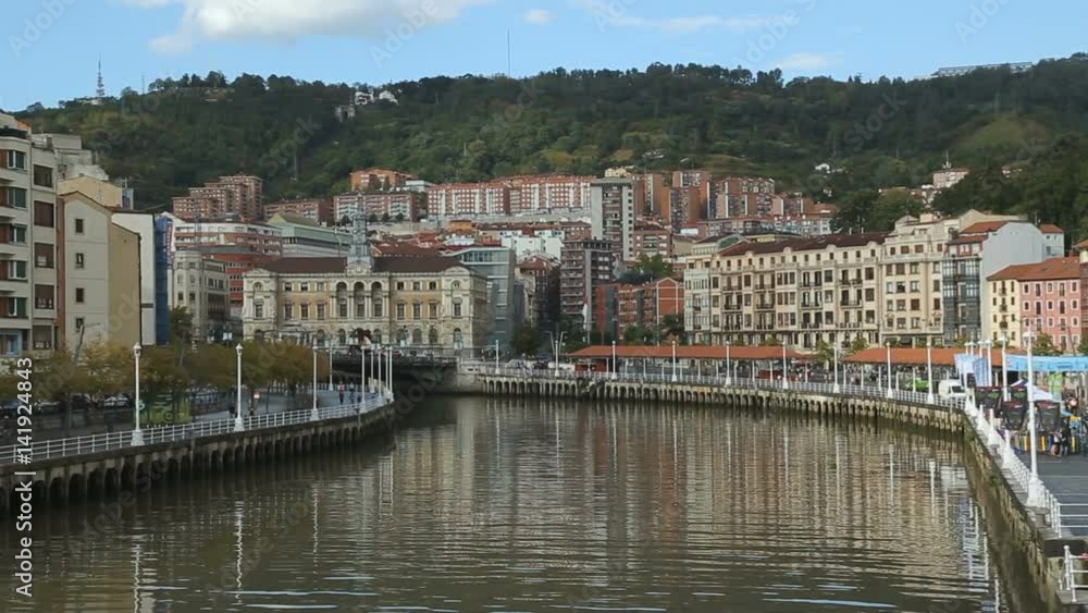 Bilbao cityscape pan, Nervion river running through city, European architecture Bilbao cityscape pan, Nervion river running through city, European architecture