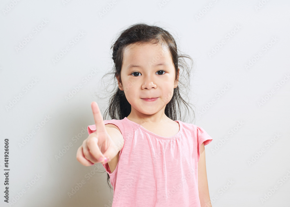 Portrait of young asian cute girl shows a finger One pose . Portrait of young asian cute girl shows a finger One pose .