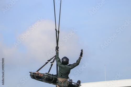 Fototapeta Naklejka Na Ścianę i Meble -  Soldier rescue emergency by army helicopter with rope  on blue sky