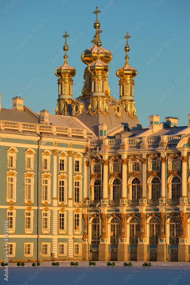 Domes of Church of the Resurrection of Catherine Palace in beams of the sunset sun close up. Tsarskoye Selo, Russia